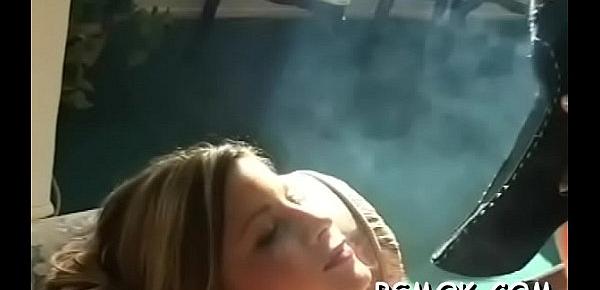  Girl enjoys a cigarette whilst putting a dick in her mouth